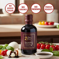 Thumbnail for Papa Vince Balsamic Vinegar bottle surrounded by fresh tomatoes and mozzarella highlighting no sugar, no caramel, no thickeners, and perfect viscosity.